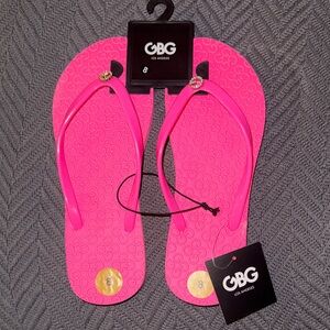 GBG Los Angeles Vibrant Pink flip flops with a bling rhinestone G in the front.